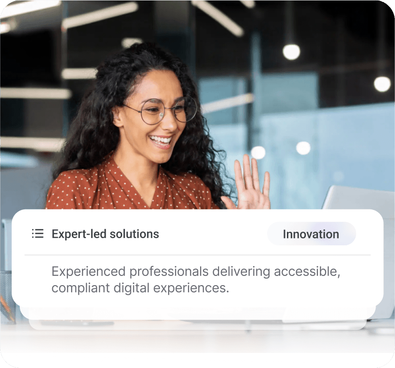 Woman with curly hair and glasses working on laptop with overlay text about expert-led accessible digital solutions and innovation.