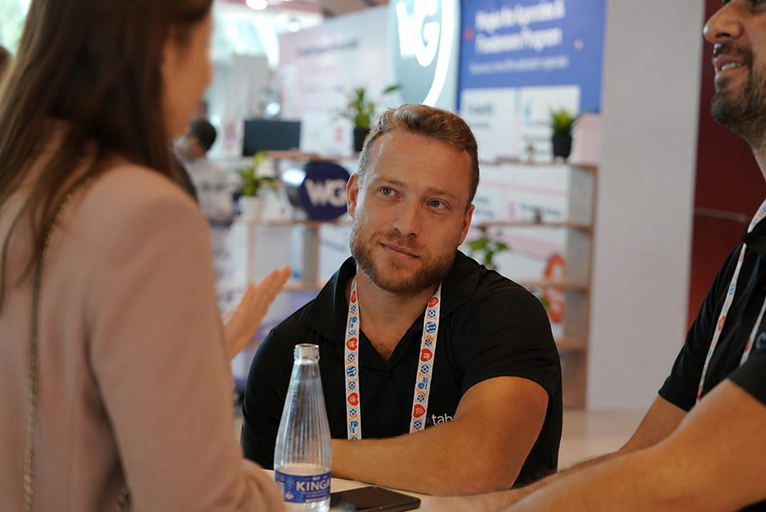 A tabnav team member talking with a customer