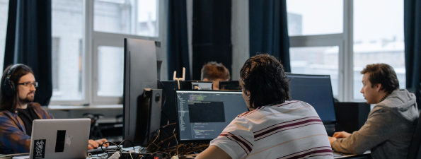 A development team working together at desktop computers in a modern office environment