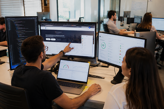 Tabnav accessibility team performing manual audits on multiple monitors
